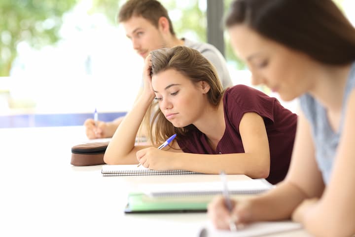 Young girl attending a lecture in college