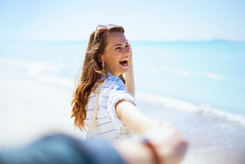 Happy Smiling Woman On Beach Aged 40