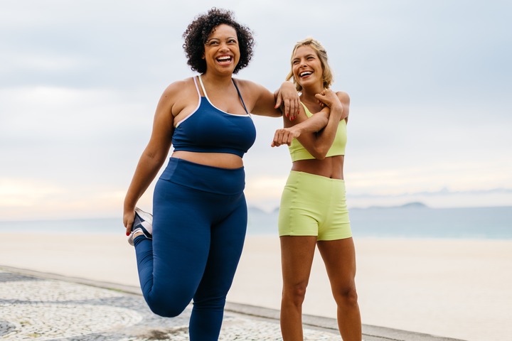 Happy women working out on a beach